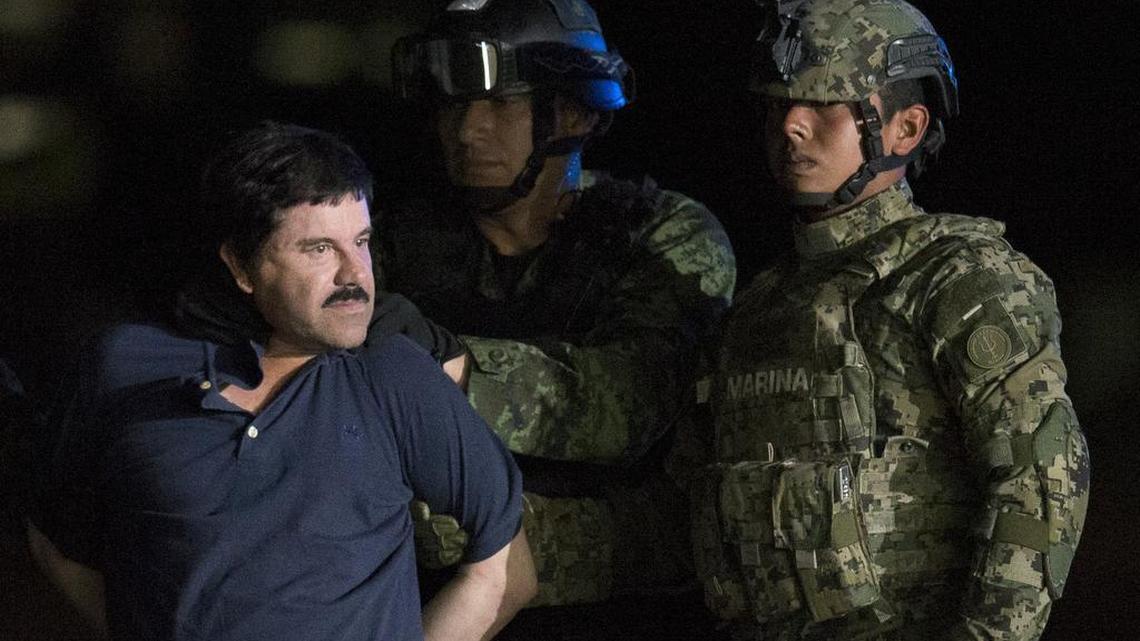 Mexican drug lord Joaquin "El Chapo" Guzman is escorted by army soldiers to a waiting helicopter, at a federal hangar in Mexico City on Jan. 8, 2016.