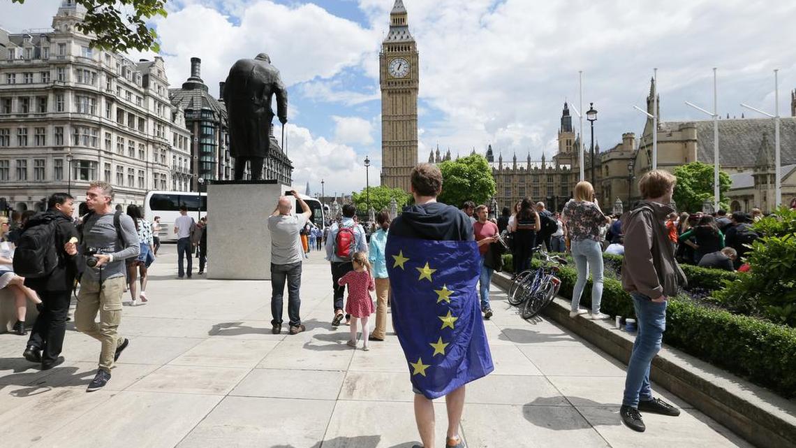 A demonstrator wrapped in the EU flag takes part in a protest opposing Britain's exit from the European Union in Parliament Square following yesterday's EU referendum result, London, Saturday, June 25, 2016. Britain voted to leave the European Union after a bitterly divisive referendum campaign.