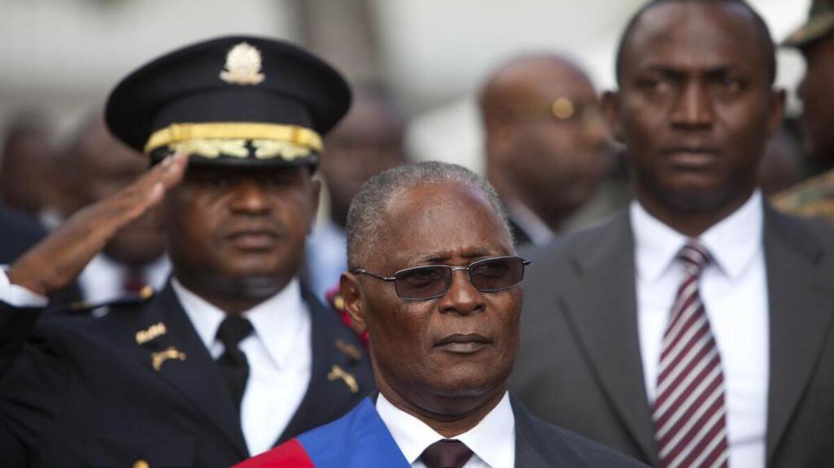 Haiti’s provisional President Jocelerme Privert stands for the playing of the national anthem after delivering his speech at an installation ceremony in Port-au-Prince, Haiti, Sunday, Feb. 14, 2016.