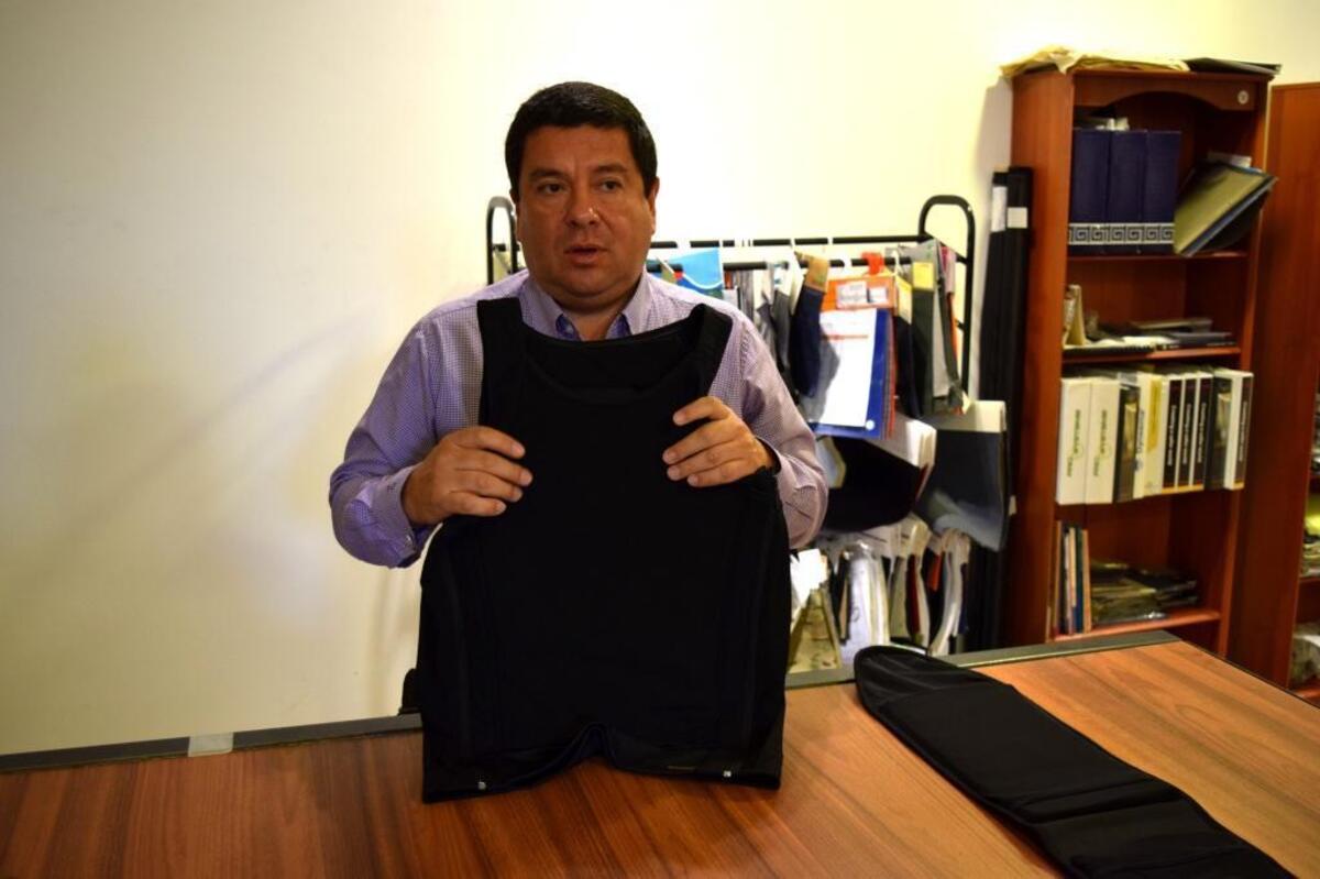Miguel Caballero, the founder of his eponymous bullet-proof clothing line, shows off his patented bulletproof t-shirt, which recently won an international design award. His company is starting to sell its products in Florida under the name MC Armor.