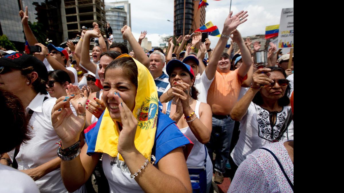 
Demonstrators cheer Lilian Tintori, the wife of jailed opposition leader Leopoldo López, during an anti-government protest in Caracas, Venezuela, Saturday. 

