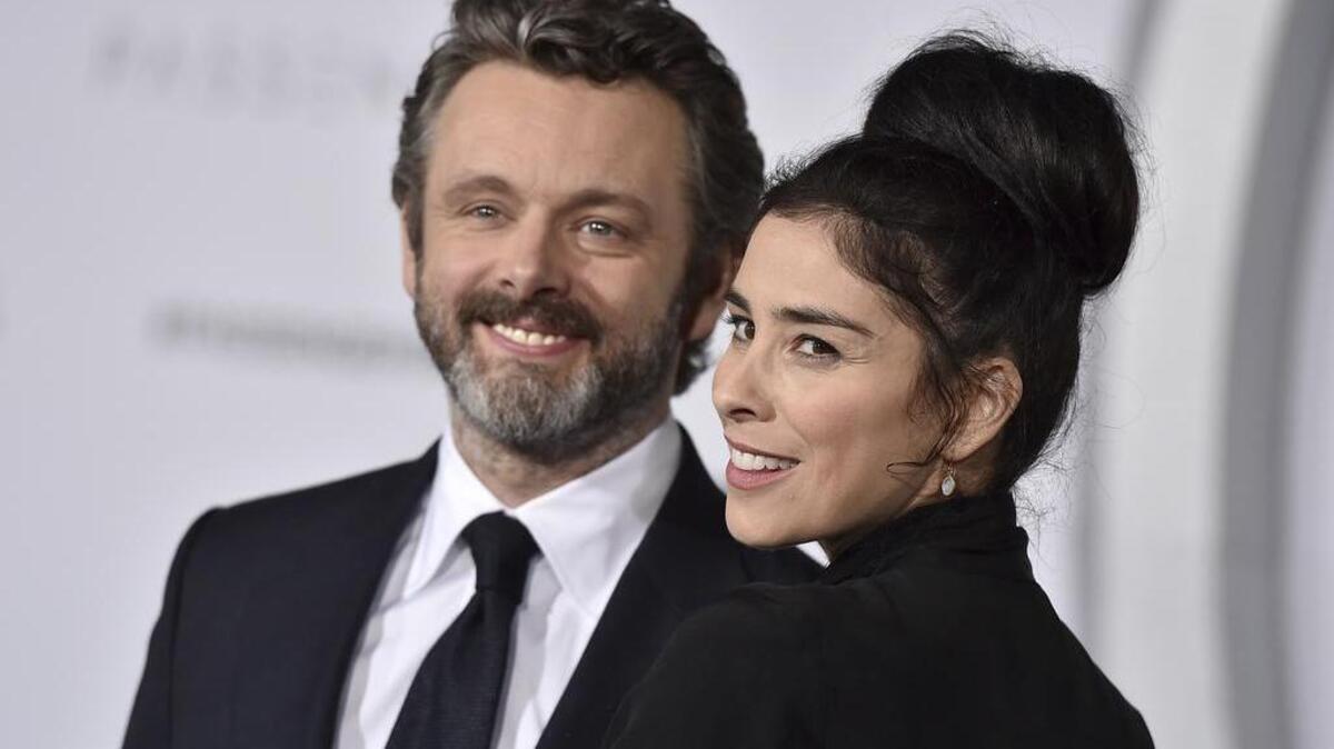 Michael Sheen, left, and Sarah Silverman arrive at the Los Angeles premiere of "Passengers" at the Village Theatre Westwood on Wednesday, Dec. 14, 2016.