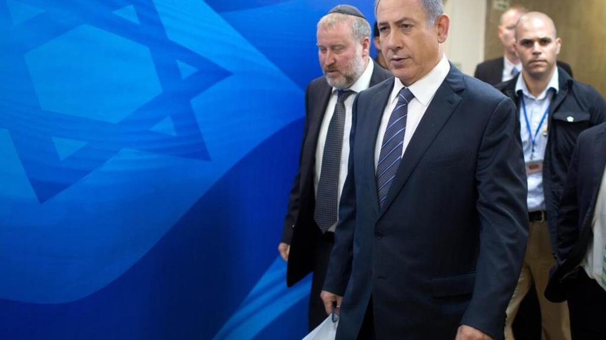 
Israeli Prime Minister Benjamin Netanyahu, second left, and Cabinet Secretary Avichai Mandelblit, left, arrive for the the weekly cabinet meeting at the prime minister's office in Jerusalem, Sunday.
