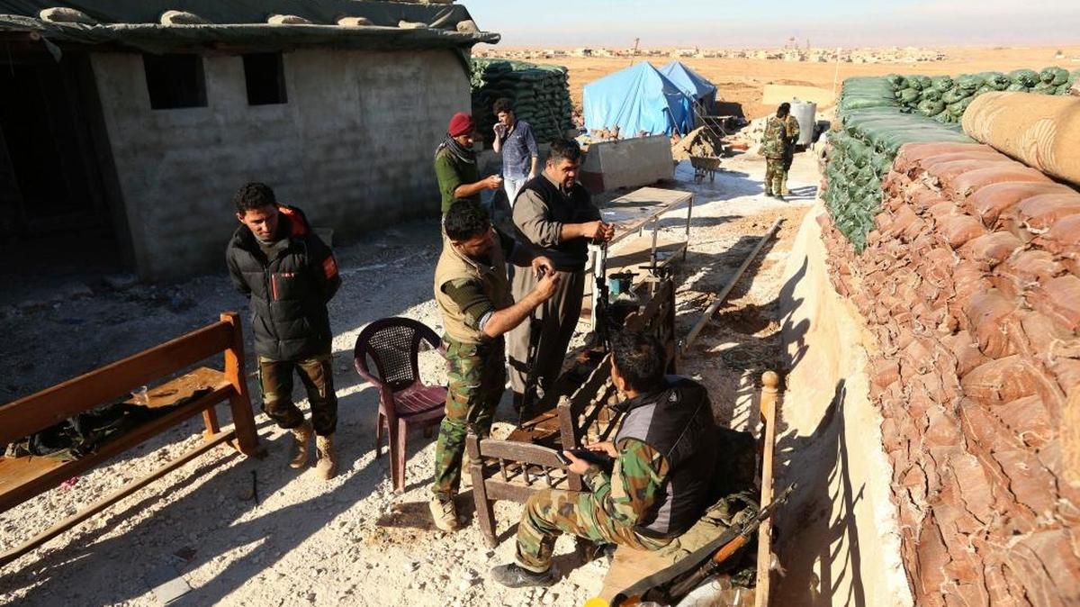 Kurdish Peshmerga fighters clean their weapons at a military base at Batnaya outside of Mosul, Iraq, Friday, Dec. 9, 2016.