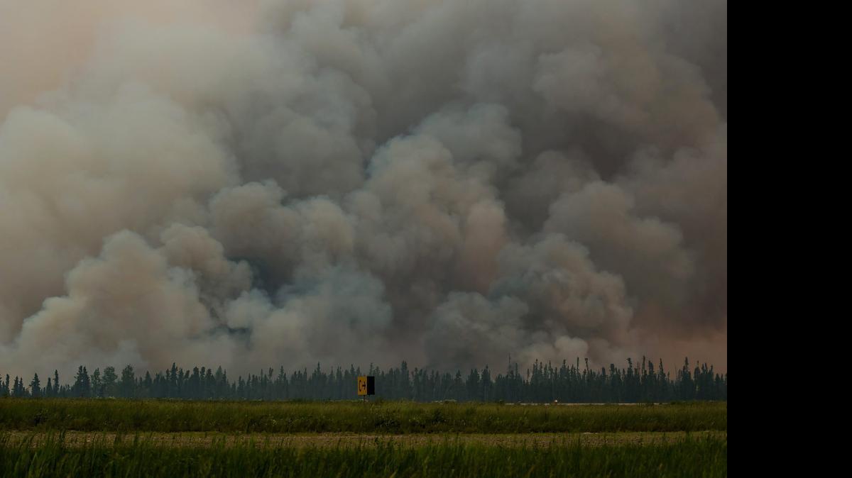 
Smoke billows from a wildfire near La Ronge, Saskatchewan, on Sunday. Canadian soldiers arrived Tuesday to help battle raging wildfires, where at least 10,000 people have been evacuated in recent days.
