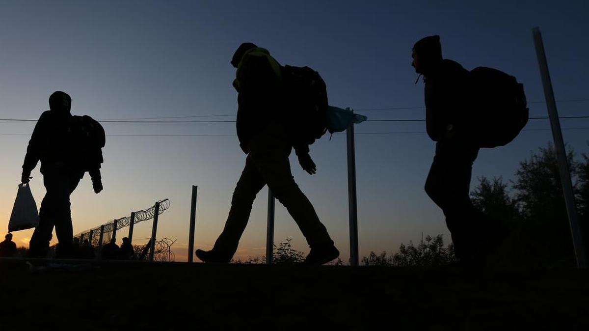 
Migrants walk near at the border between Serbia and Hungary in Roszke, southern Hungary, Monday, Sept. 14, 2015. 
