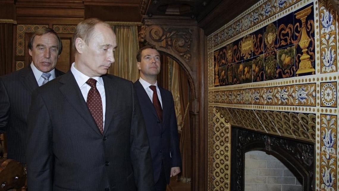 Russian President Vladimir Putin, then prime minister of the country, visits a former palace of Great Prince Alexei Alexandrovich Pomanov, in St. Petersburg, Russia, with longtime friend Sergei Roldugin, and then-president Dmitry Medvedev, on Nov. 21, 2009. A leak of records from an international law firm shows that Roldugin is a behind-the-scenes player in a clandestine network operated by Putin associates that has shuffled at least $2 billion through banks and offshore companies.