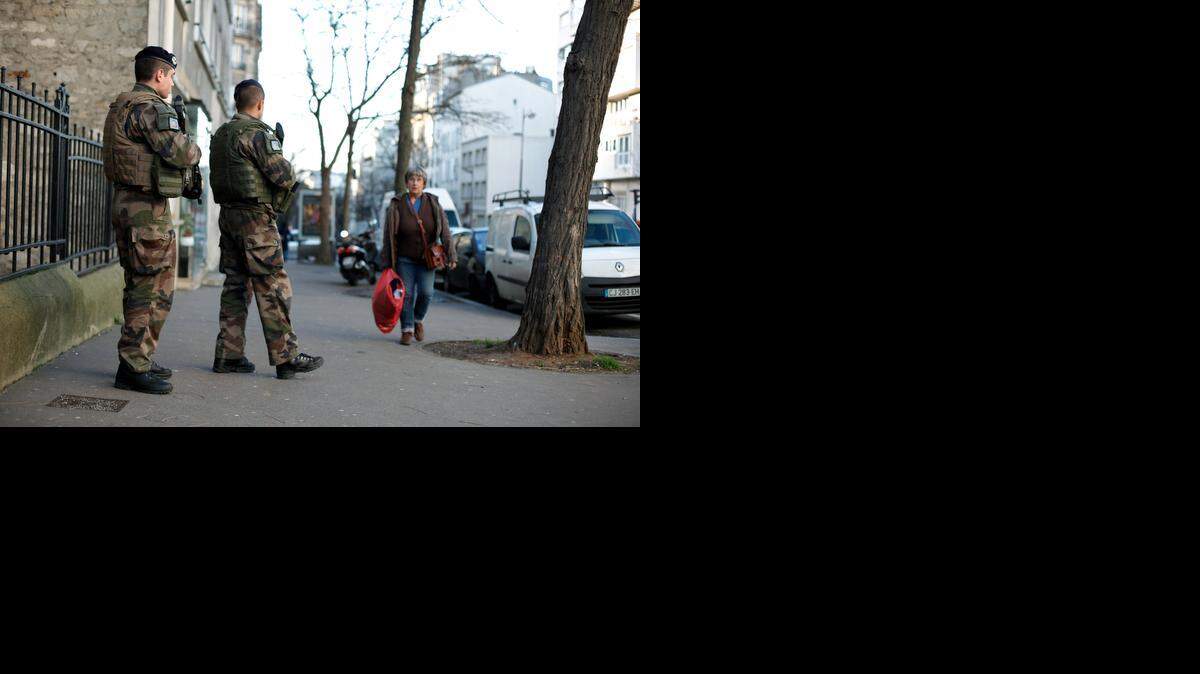 
French soldiers secure the access to a Jewish school in Paris as part of the highest level of "Vigipirate" security plan after last week's attacks by Islamist militants, Wednesday, Jan. 14, 2015. 
