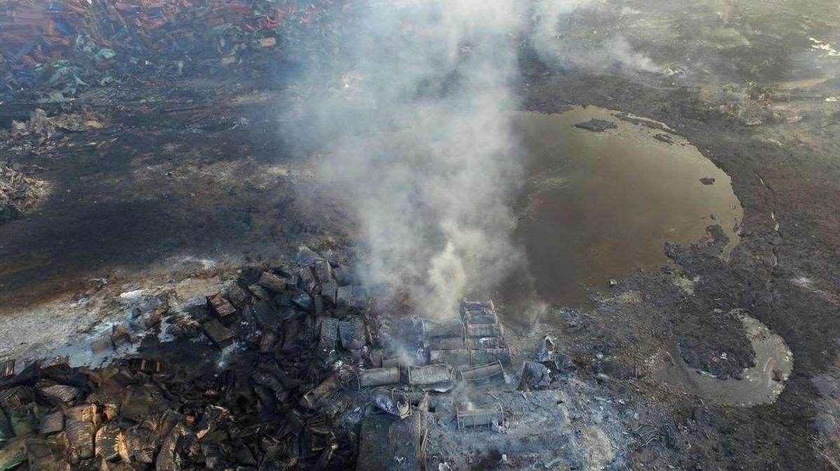 
Smoke rises from debris near a crater that was at the center of a series of explosions in northeastern China's Tianjin municipality Saturday, Aug. 15, 2015. New explosions and fires on Saturday prompted authorities to order an evacaution zone of nearly two miles around the site.
