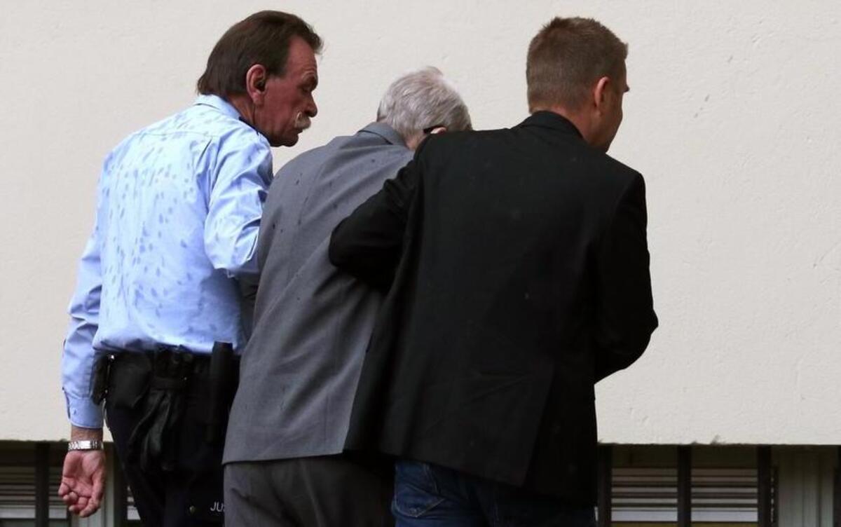 94-year-old former SS sergeant Reinhold Hanning, center, who served as a guard in Auschwitz is led to the court in Detmold, Germany Friday, June 17, 2016.