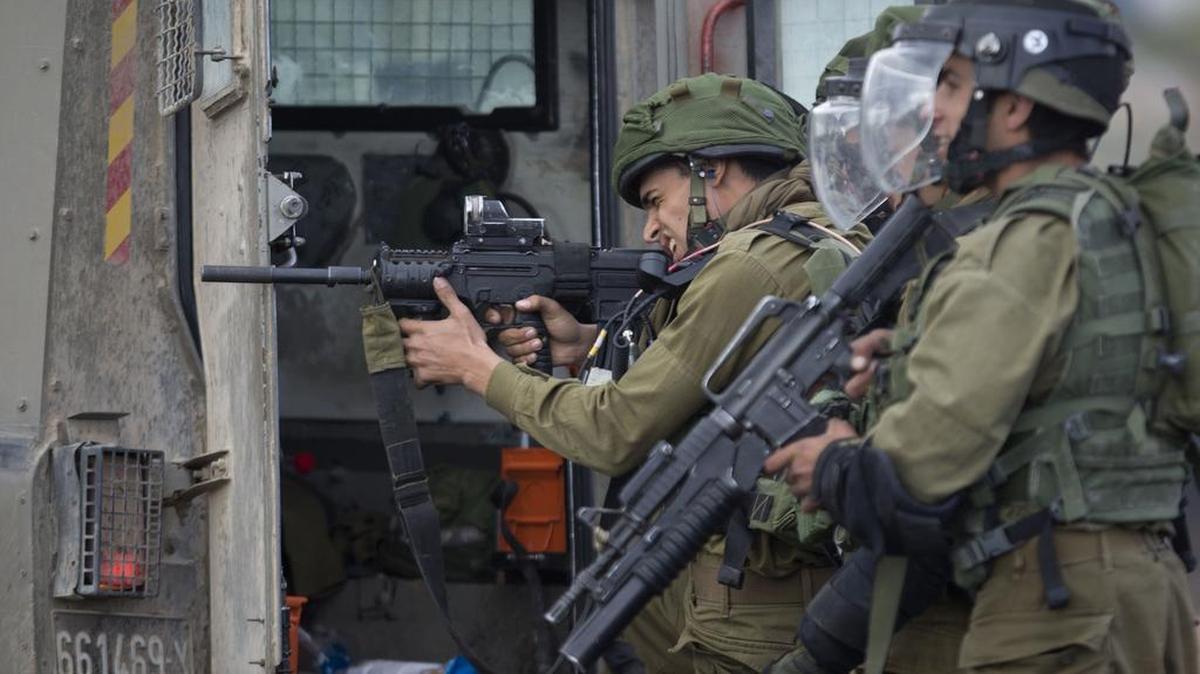 
Israeli troops take aim, during clashes with Palestinians near Ramallah in the West Bank on Friday. 
