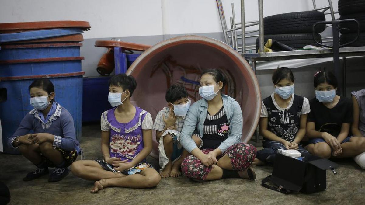 In this Monday, Nov. 9, 2015 photo, children and teenagers sit together to be registered by officials during a raid on a shrimp shed in Samut Sakhon, Thailand. Abuse is common in Samut Sakhon, which attracts workers from some of the world’s poorest countries, mostly from Myanmar. An International Labor Organization report estimated 10,000 migrant children aged 13 to 15 work in the city. Another U.N. agency study found nearly 60 percent of Burmese laborers toiling in its seafood processing industry were victims of forced labor.