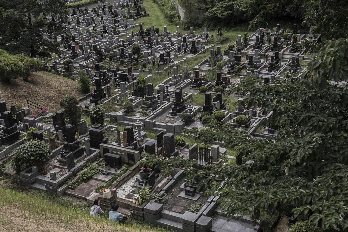 A cemetery outside Tokyo, Sept. 12, 2016. Nearly all people who die in Japan are cremated. Crematories cannot keep up with demand, so businesses are combining hospitality for families and temporary storage for bodies.