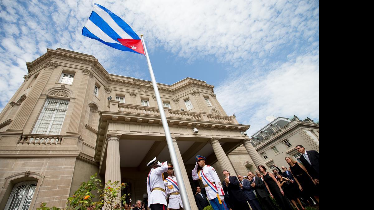 
Cuban Foreign Minister Bruno Rodriguez, right of center, applauds with other dignitaries after raising the Cuban flag over their new embassy in Washington, Monday, July 20, 2015. Cuba's blue, red and white-starred flag was hoisted Monday at the country's embassy in Washington in a symbolic move signaling the start of a new post-Cold War era in U.S.-Cuba relations. 
