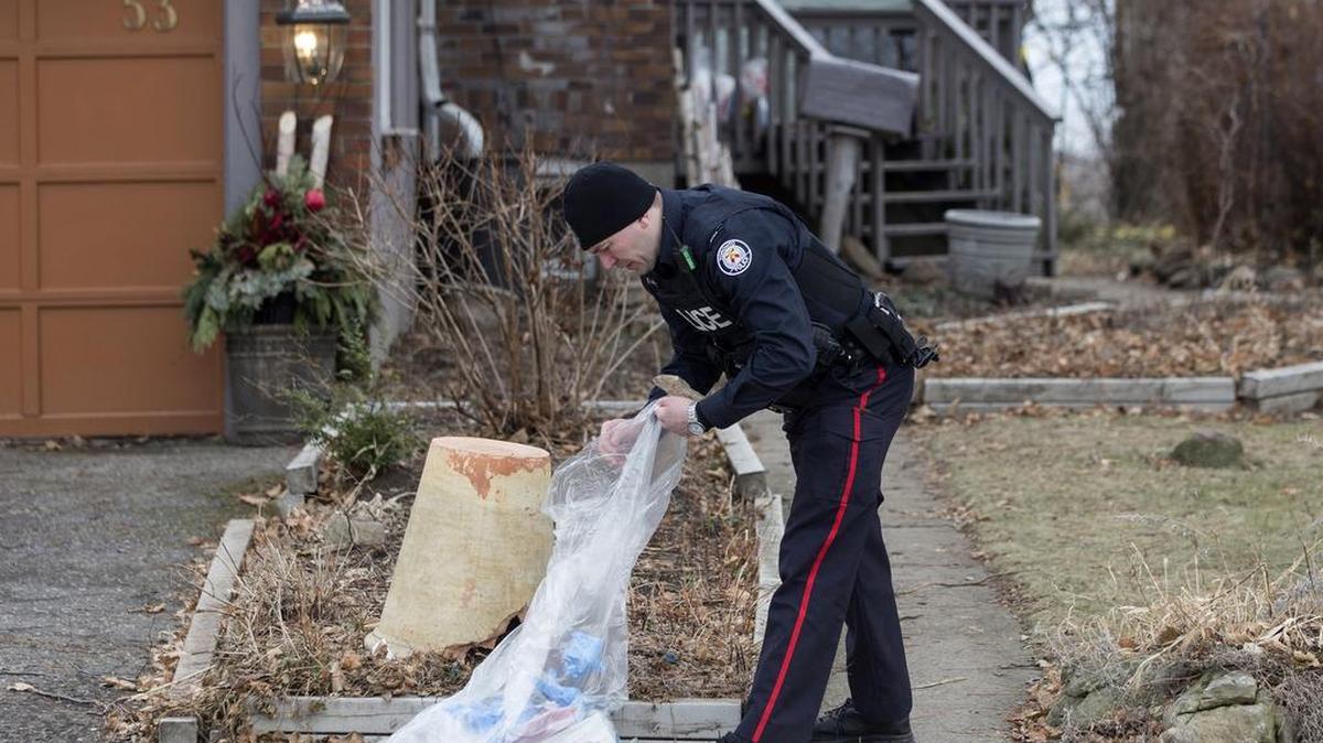 A police officer investigates outside a home in Toronto, Canada, where Bruce McArthur did landscape work. The burly 66-year-old landscaper, suspected of being a serial killer, went on a date with 52-year-old Peter Sgromo last April.