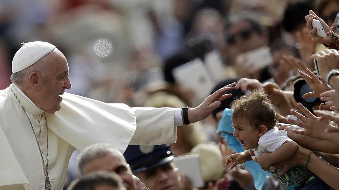 
Pope Francis blesses a child as he arrives for the weekly general audience in St. Peter’s Square at the Vatican on Wednesday, Sept. 16, 2015. Hundreds of thousands are expected to try to get a glimpse of the pontiff when he visits Washington, New York and Philadelphia starting Tuesday.
