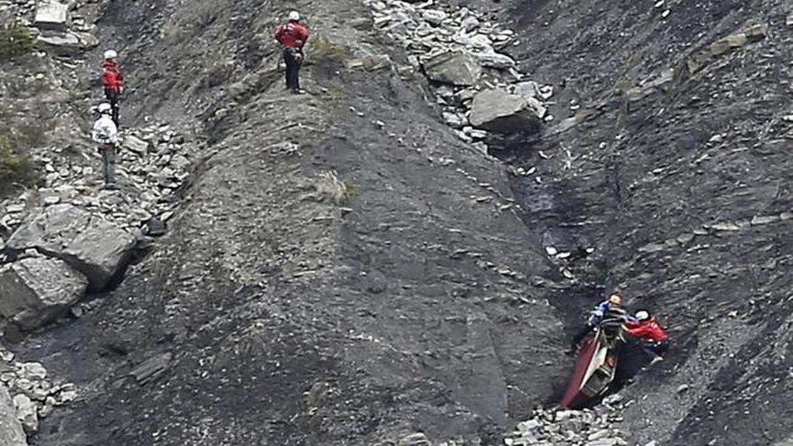 
Rescue workers work on debris at the plane crash site near Seyne-les-Alpes, France, Wednesday, March 25, 2015, after a Germanwings jetliner crashed Tuesday in the French Alps. 
