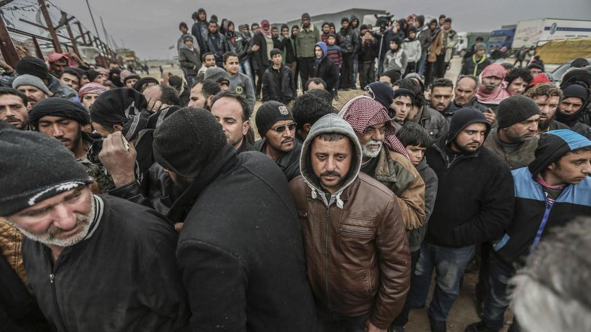 Syrians gather at the Bab al-Salam border gate with Turkey, in Syria, Feb. 6, 2016. Thousands of Syrians have rushed toward the Turkish border, fleeing fierce Syrian government offensives and intense Russian airstrikes.