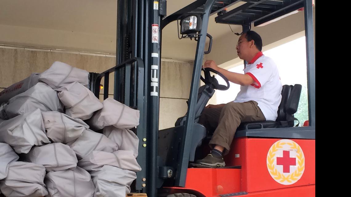 
A Red Cross worker operates a forklift carrying tents at a warehouse in Beijing Monday, April 27, 2015. The Chinese Red Cross shipped 2,000 tents by air to Kathmandu on Monday as part of its relief efforts for the earthquake in Nepal, which the agency said would be enough to shelter 10,000 to 12,000 people.
