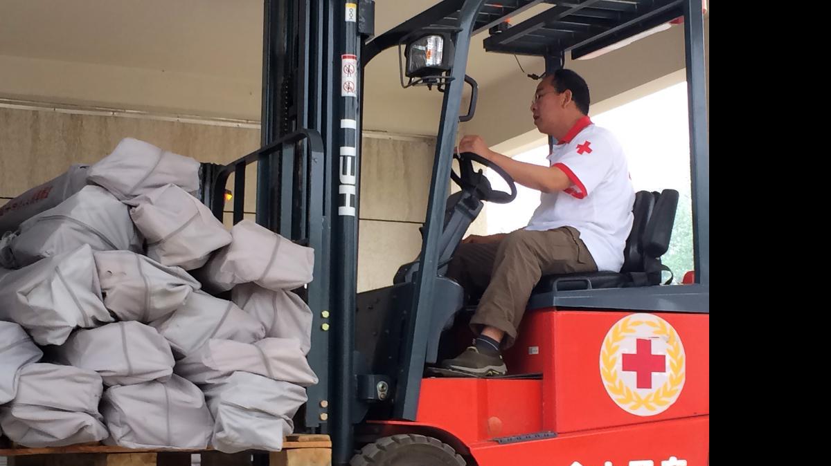 
A Red Cross worker operates a forklift carrying tents at a warehouse in Beijing Monday, April 27, 2015. The Chinese Red Cross shipped 2,000 tents by air to Kathmandu on Monday as part of its relief efforts for the earthquake in Nepal, which the agency said would be enough to shelter 10,000 to 12,000 people.
