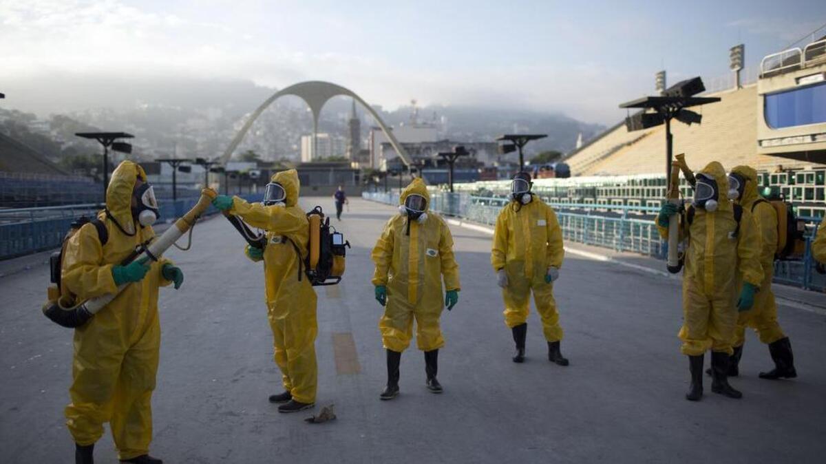 Health workers get ready to spray insecticide to combat the mosquitoes that transmit the Zika virus at the Sambadrome in Rio de Janeiro in January. A letter Friday from 150 international public health experts urges the Rio Olympic Games this summer be delayed or relocated “in the name of public health.”