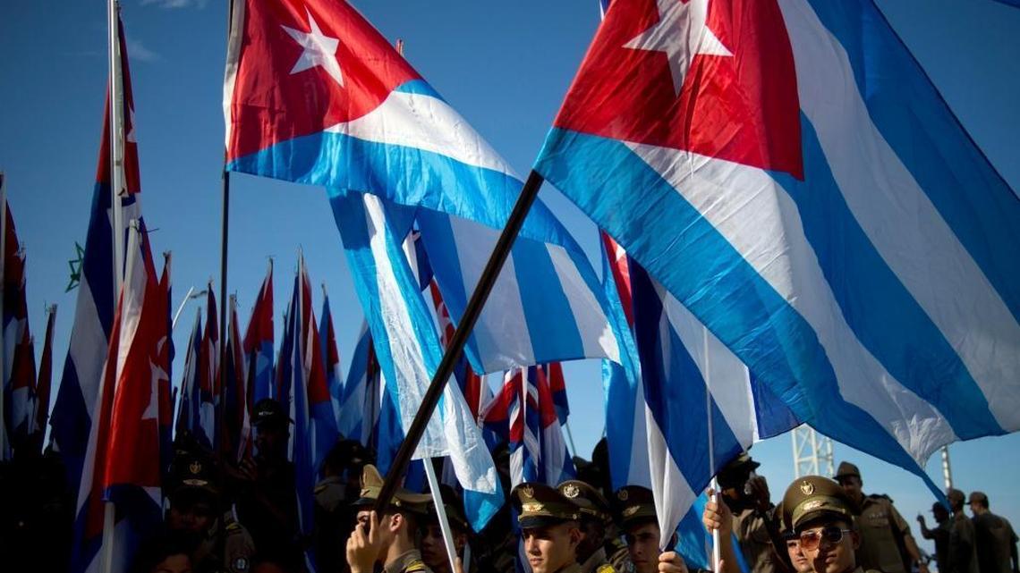 Students march carrying Cuban flags during a march against terrorism in Havana, Cuba, Tuesday, Sept. 30, 2014. Youths marched today through downtown Havana in protest against the United States policy towards the island nation and demanding the that U.S. free three Cuban agents imprisoned there.