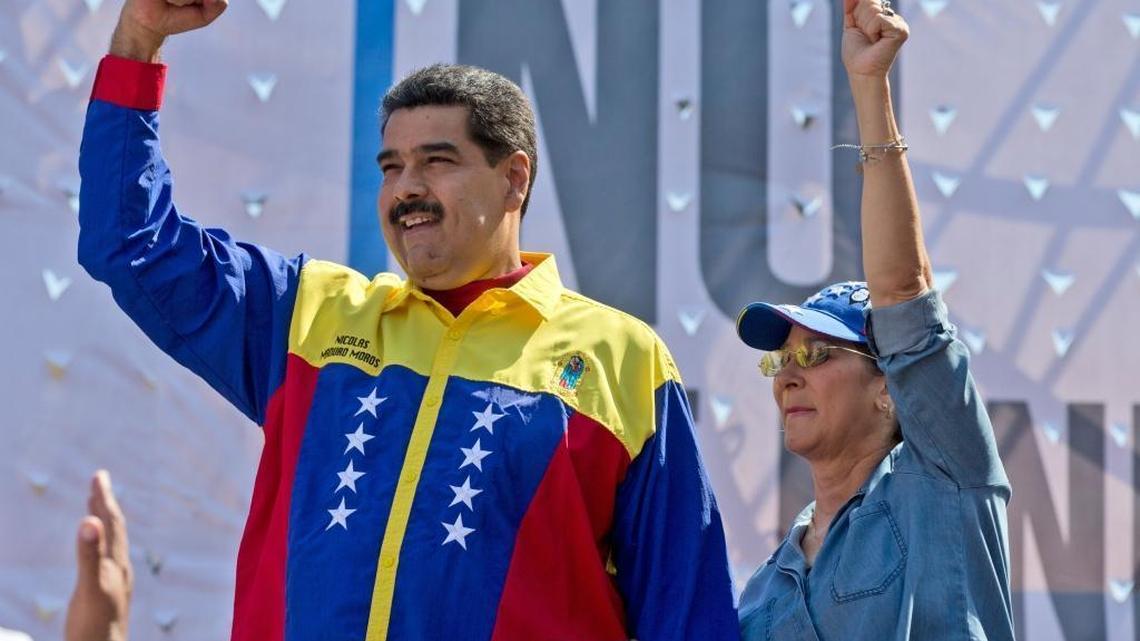 Venezuela's President Nicolas Maduro, left, and his wife Cilia Flores, greet supporters as they arrive to take part in an anti-U.S. rally, in Caracas, Venezuela, Saturday, March 12, 2016.