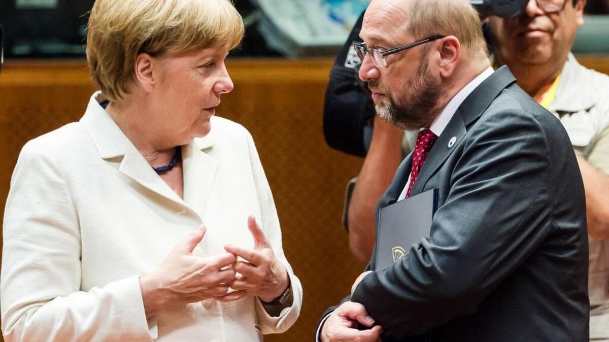 
German Chancellor Angela Merkel, left, speaks with European Parliament President Martin Schultz during a meeting of eurozone heads of state at the EU Council building in Brussels on Sunday, July 12, 2015. She has gone from being portrayed as the heartless villain in Europe’s debt crisis to the heroine of those flooding in to find refuge on the continent. 
