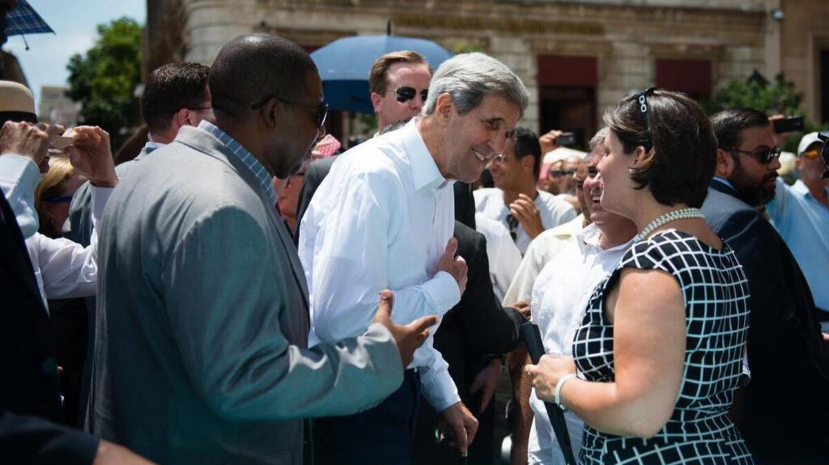 
After the flag-raising ceremony in Havana, U.S. Secretary of State John Kerry visited Plaza San Francisco in old Havana. He speaks to Julio Alvarez Torres and his wife, Niliales Acosta, who run a business that highlights the island nation’s 1950s car culture. 
