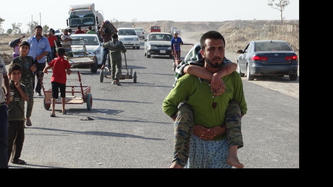 
Iraqi family members who left their hometown of Ramadi walk towards Baghdad, outside Ramadi, the capital of Anbar province, 70 miles west of Baghdad, Iraq, Friday, May 15, 2015. Islamic State militants seized the center of Ramadi in western Iraq and raised their black flag over the government compound, local officials said.

