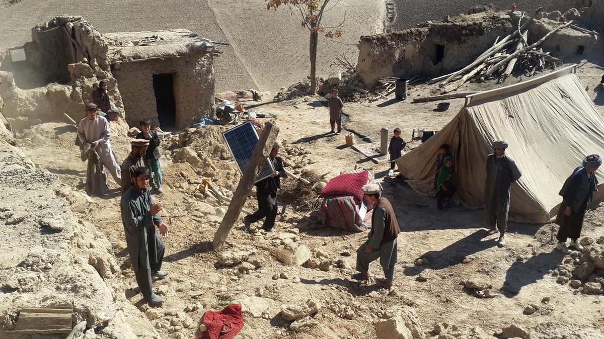 Afghan men carry their belongings after an earthquake in Takhar province, northeast of Kabul, Afghanistan, Tuesday, Oct. 27, 2015. Rescuers were struggling to reach quake-stricken regions in Pakistan and Afghanistan on Tuesday as officials said the combined death toll from the previous day's earthquake rose to more than 300.