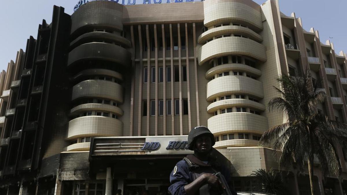 A soldier stands guard outside the Splendid Hotel in Ouagadougou, Burkina Faso, on Sunday, Jan. 17, 2016. The overnight seizure of a luxury hotel in Burkina Faso’s capital by al-Qaida-linked extremists ended Saturday when Burkina Faso and French security forces killed four jihadist attackers and freed more than 126 people, the West African nation’s president said.