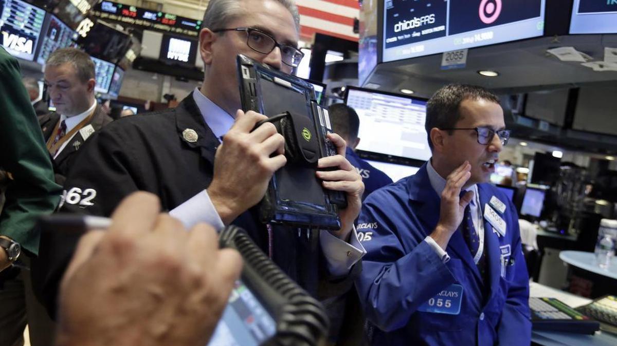 
Specialist Neil Gallagher, right, calls out prices as he works at his post on the floor of the New York Stock Exchange, Wednesday, Aug. 26, 2015. U.S. stocks are opening sharply higher Wednesday after slumping for six straight days amid concern that growth in China was slowing more quickly than previously thought. 
