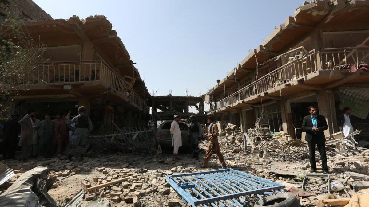 
Afghans gather at the site of a car bomb attack in Kabul, Afghanistan, Friday, Aug. 7, 2015. A bomb hidden in a truck exploded in the center of the Afghan capital, killing several people and wounding hundreds, police and health officials said Friday. Police chief Abdul Rahman Rahimi said the pre-dawn blast was near a Defense Ministry compound, but that all of the victims were civilians, including women and children. 
