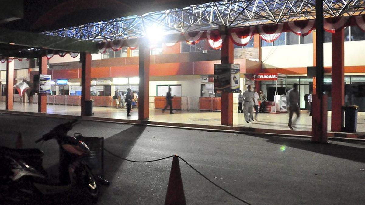 
People walk outside the terminal at Sentani Airport in Jayapura, Papua province, Indonesia, Sunday after a Trigana Air Service flight originating from there went missing. 
