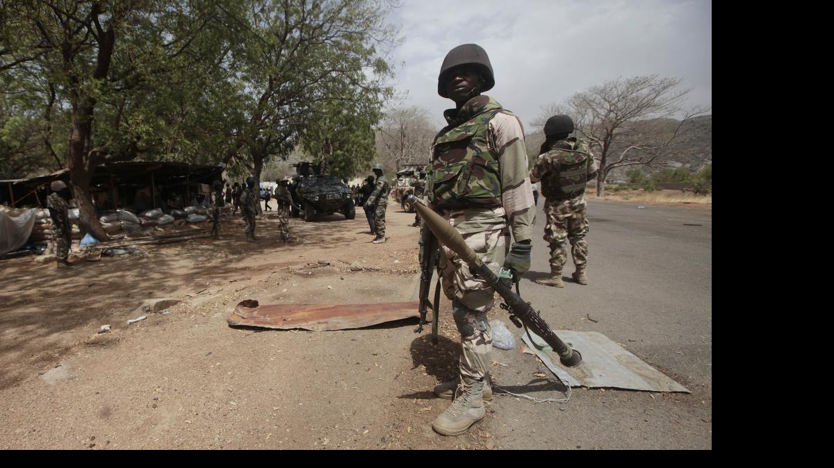 
In this file photo taken Wednesday, April 8, 2015, Nigerian Soldiers man a check point in Gwoza, Nigeria, a town newly liberated from Boko Haram. Nigeria's military says it is moving 200 girls and 93 women from a northeastern forest where they were rescued from Boko Haram extremists. 
