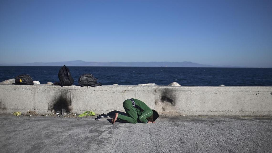 An Iraqi man prays at the port of Mytilene on the island of Lesbos, Greece, Monday, Nov. 2, 2015.