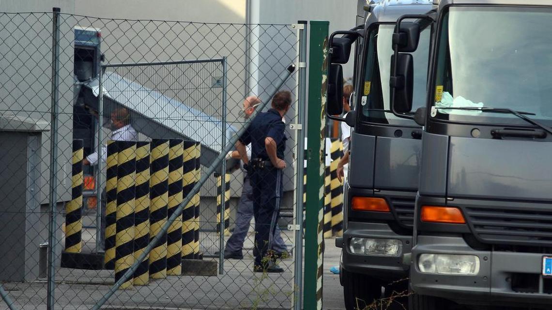 
A coffin is carried to a hearse at a veterinary border station at the Austrian/Hungarian border in Nickelsdorf, Austria, Friday, Aug 28, 2015. A truck was found parked on a main Austrian highway on Thursday with 71 migrants suffocated to death.
