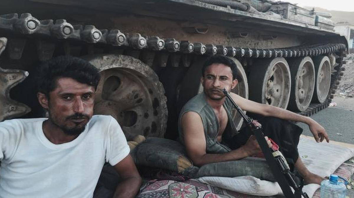 
In this photo from March 21, 2015, members of a militia group loyal to Yemen’s President Abed Rabbo Mansour Hadi, known as the Popular Committees, chew qat as they sit next to their tank, guarding a major intersection in Aden, Yemen. Forces loyal to Hadi were reportedly fracturing Wednesday amid reports that he had fled the country.
