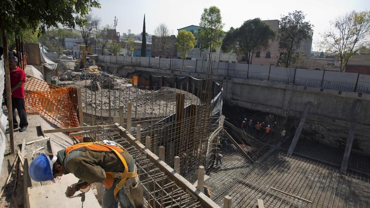 A construction worker labors near a temple dedicated to the god of wind Ehecatl-Quetzalcoatl, unearthed at the site of a shopping center being built in Mexico City, Wednesday, Nov. 30, 2016. Archeologists from Mexicoâ€™s National Anthropology and History Institute say this structure where eight sets of human remains were found is worth preserving and will eventually be made accessible to the public.