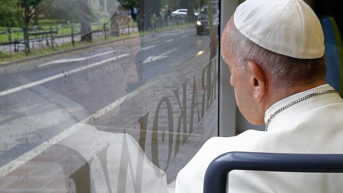 Pope Francis looks out of the window as he drives in a public transportation tram to reach the venue of the World Youth Days in Krakow, Poland, July 28, 2016.