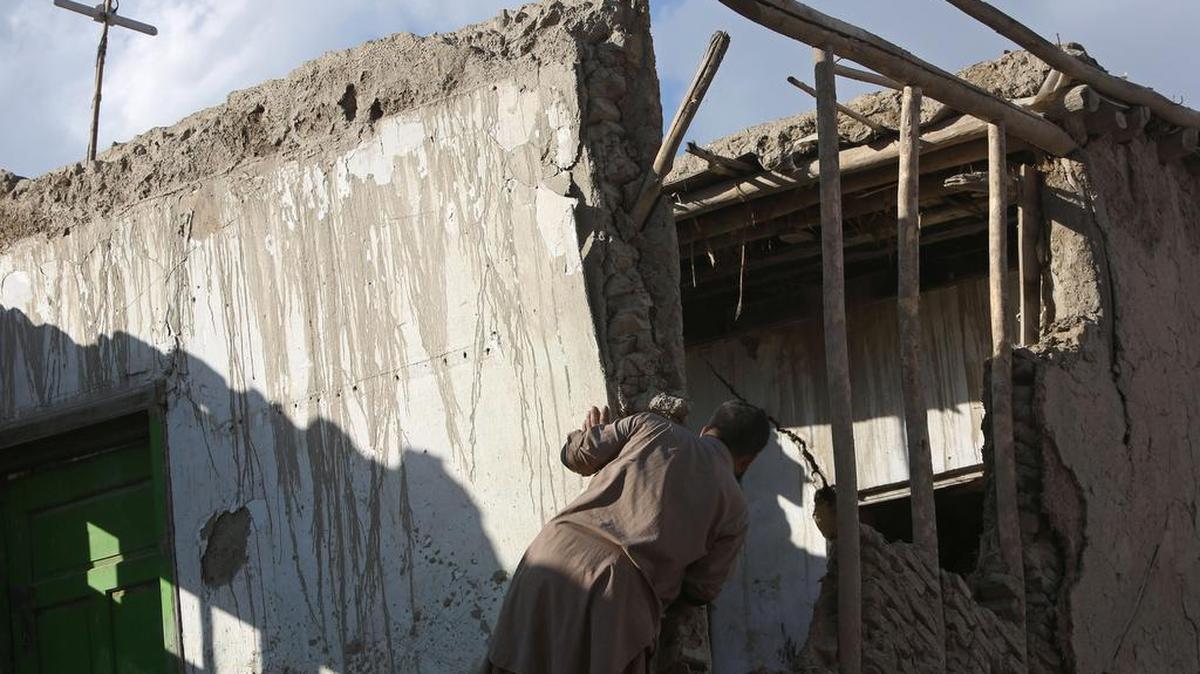An Afghan man looks at a damaged house following a powerful earthquake today that could be felt across South Asia, in Kabul, Afghanistan, Monday, Oct. 26, 2015.