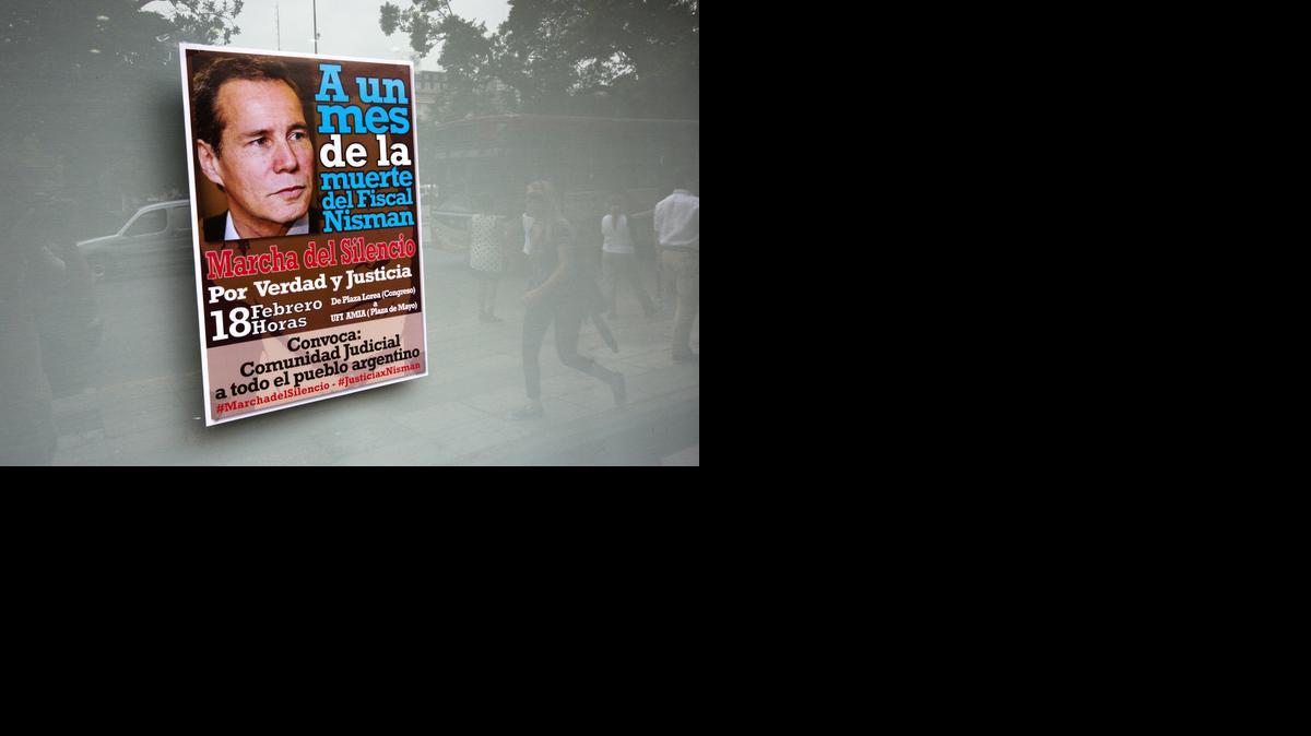 
In this Feb. 10, 2015 file photo, a poster of late prosecutor Alberto Nisman announces a protest demanding justice in the case of his death, hangs on a window one month after he was found dead in Buenos Aires, Argentina. 

