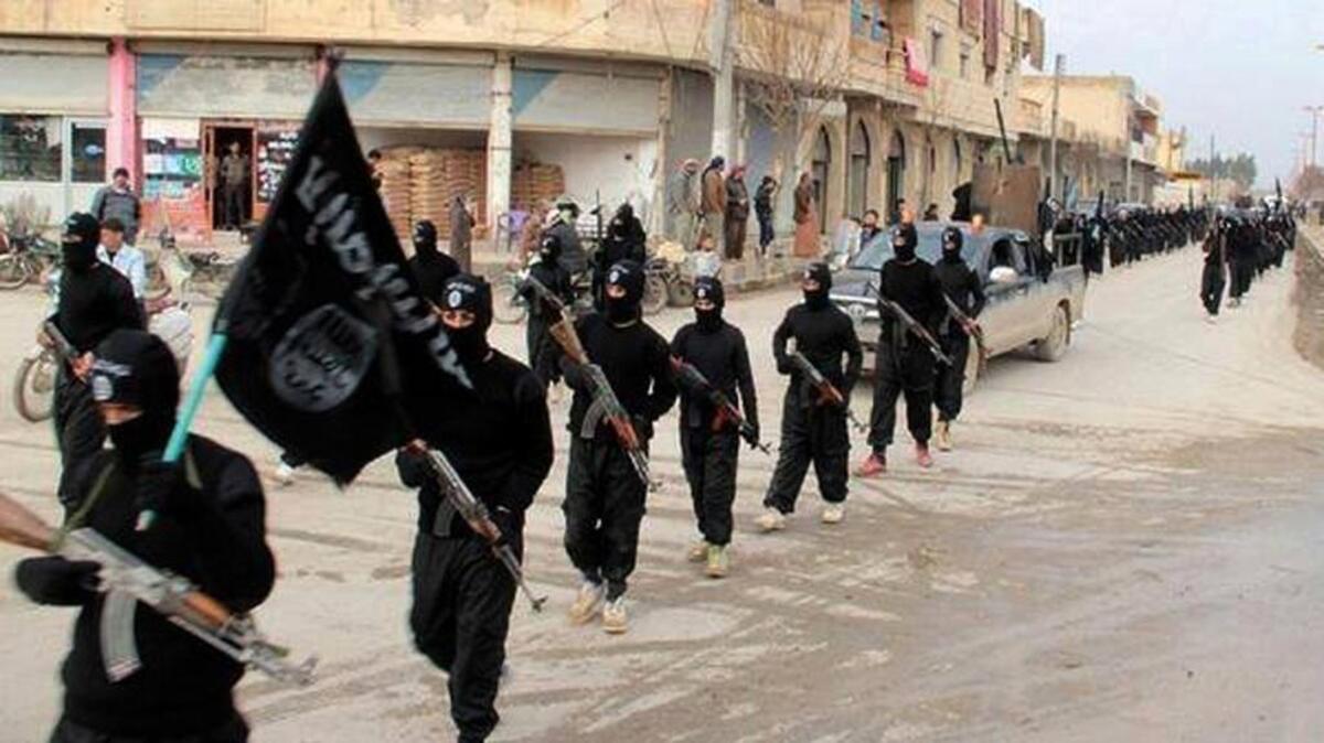 
This undated photo of victorious Islamic State forces marching in Raqqa, Syria, reflect the three-part battle in Syria among Assad regime forces, jihadists and American-supported rebels. Two rebel commanders have been assassinated in two weeks. 
