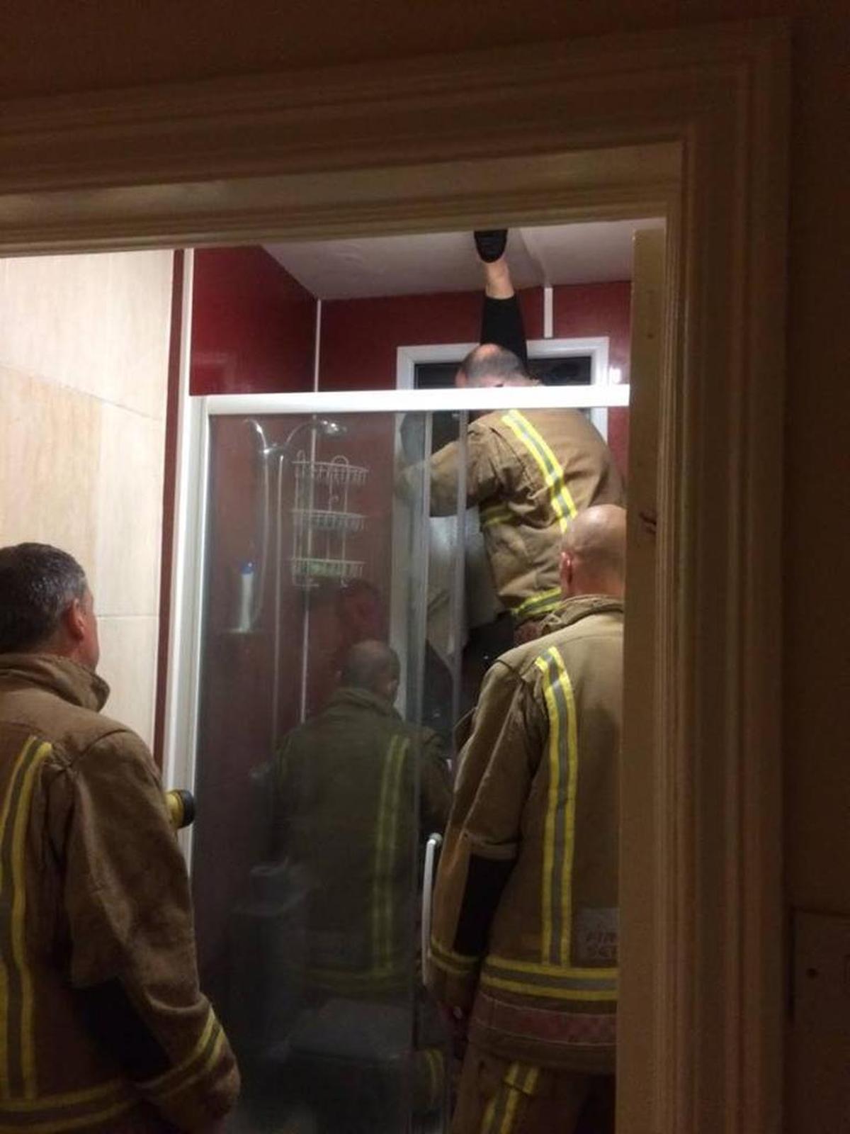 Firemen freeing Smyth’s date from the window.