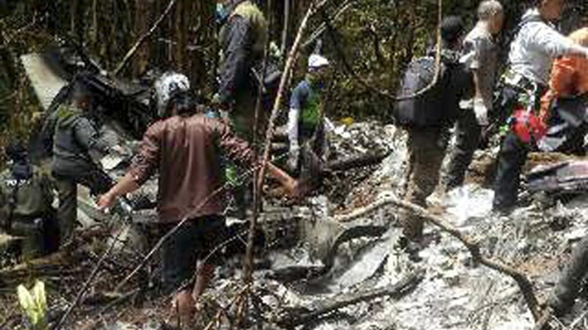 
Officials and more than 70 rescue workers gather plane wreckage strewn across dense terrain in a remote area of Pegunungan Bintang in Indonesia’s Papua province on Tuesday, Aug. 18, 2015. The Trigana Air Service plane that went missing two days ago was destroyed when it slammed into a mountain at 8,500 feet, killing all 54 people on board, the country’s top rescue official said.
