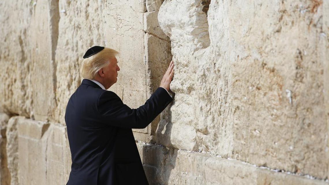 President Donald Trump touches the Western Wall, Judaism’s holiest prayer site, in Jerusalem’s Old City, Monday, May 22, 2017.