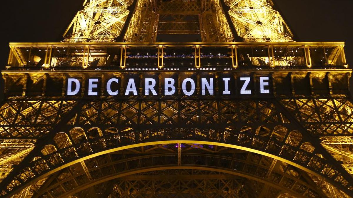 The slogan "DECARBONIZE" is projected on the Eiffel Tower as part of the COP21, United Nations Climate Change Conference in Paris, France, Dec. 11, 2015.