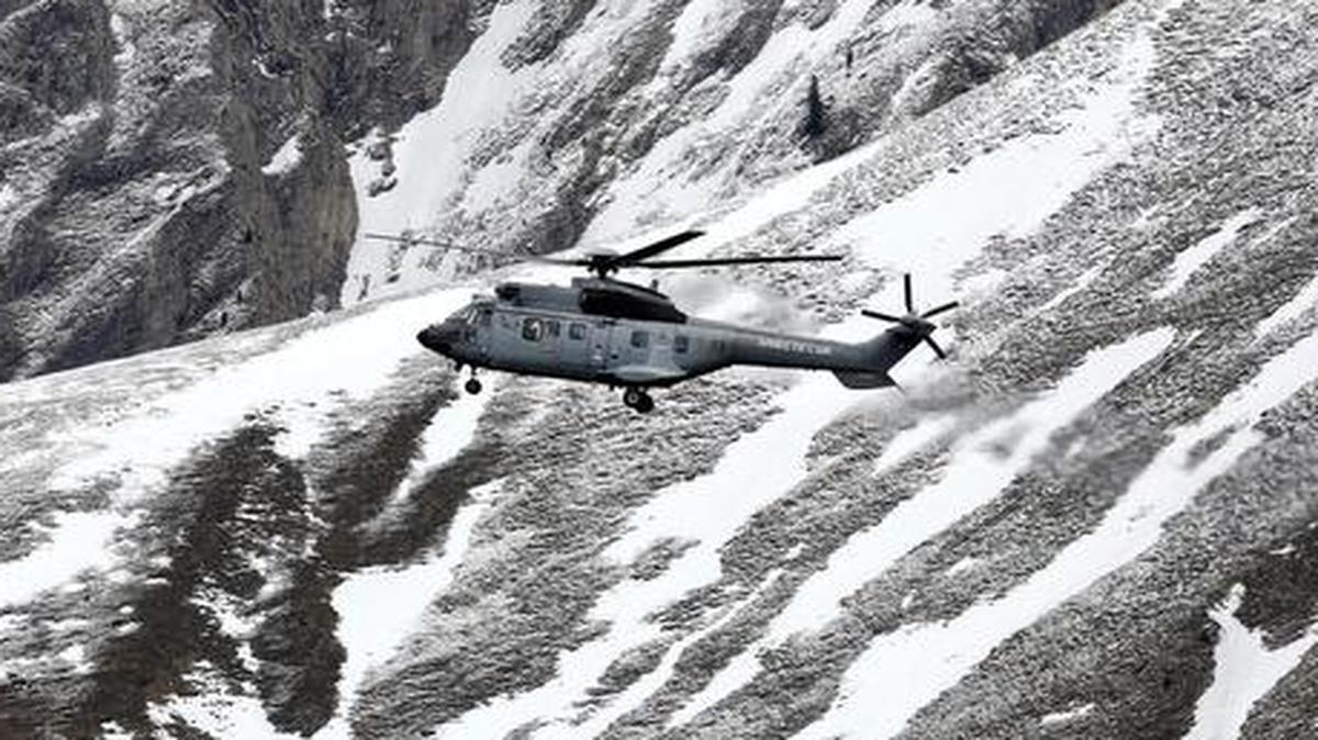 
A French army helicopter heads to the Germanwings flight crash site near Seyne-les-Alpes, Wednesday, March 25, 2015, after the jetliner crashed Tuesday in the French Alps. French investigators cracked open the badly damaged black box of a German jetliner on Wednesday and sealed off the rugged Alpine crash site where 150 people died when their plane on a flight from Barcelona, Spain to Duesseldorf, Germany, slammed into a mountain. 
