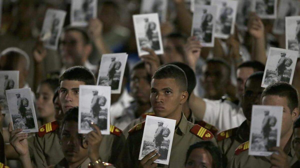 Military cadets hold pictures of Fidel Castro during a rally at the Plaza of the Revolution in Havana on Tuesday, Nov. 29, 2016.